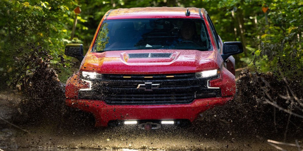 Red XT1 off-roading through water